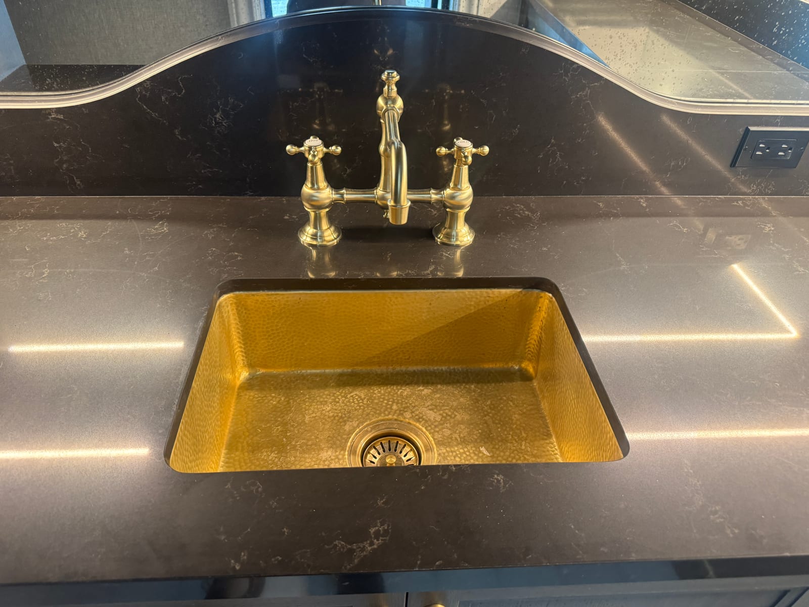 Brass kitchen sink and fixtures polished to a shine
