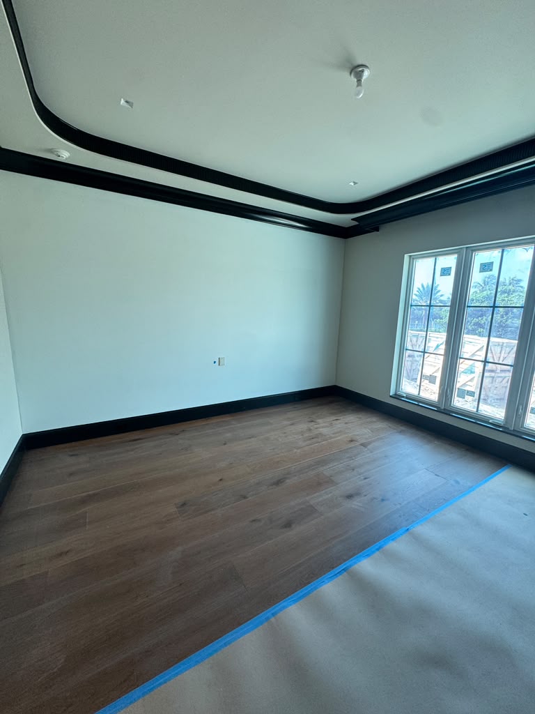 Freshly cleaned bedroom with gleaming hardwood floor